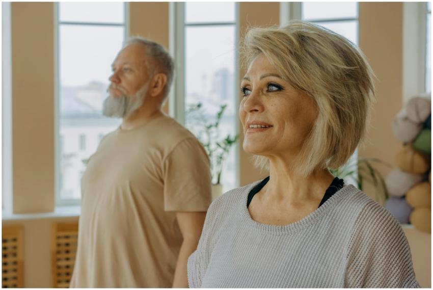 Senior couple at a wellness studio enjoying yoga a