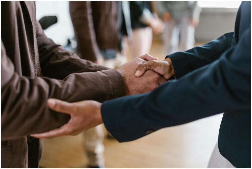 Close-up of two businesspeople shaking hands, symb