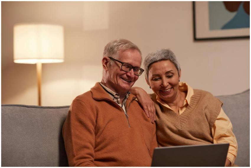 Senior couple enjoying time together on laptop ind