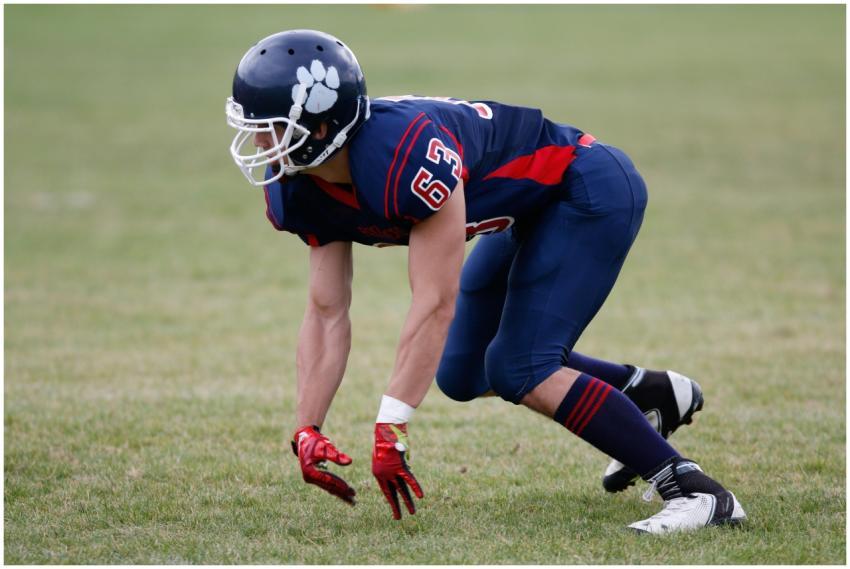 A focused American football player in uniform prep