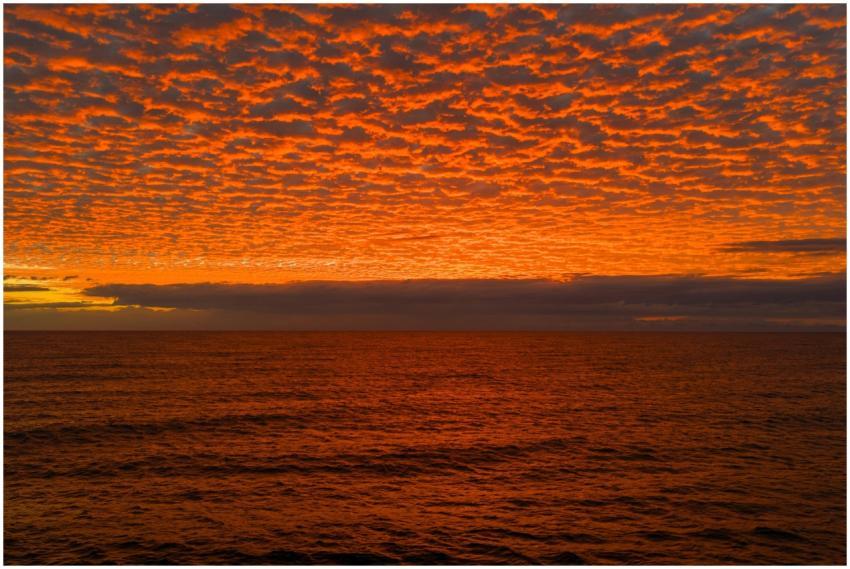 A mesmerizing sunset with vibrant orange clouds ov