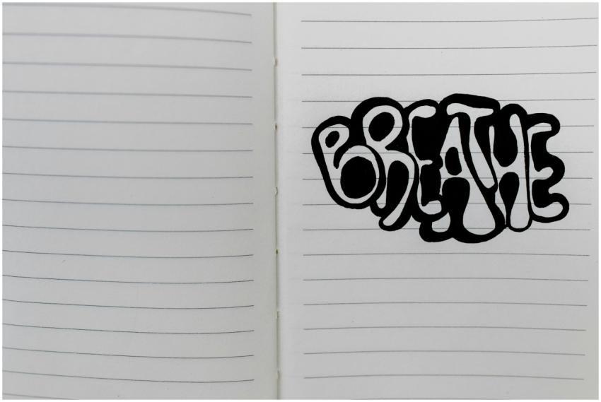 Handwritten word 'breathe' in bold letters on open
