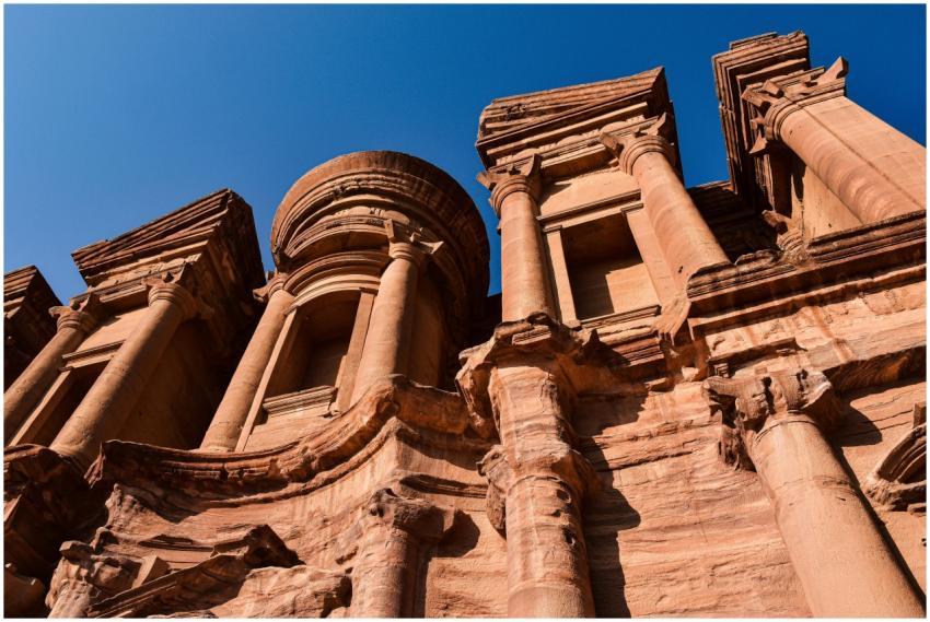 A low angle view of the sunlit columns of The Mona