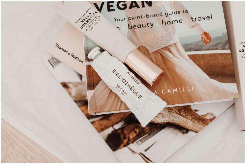 Minimalist flat lay with cosmetics and magazines s