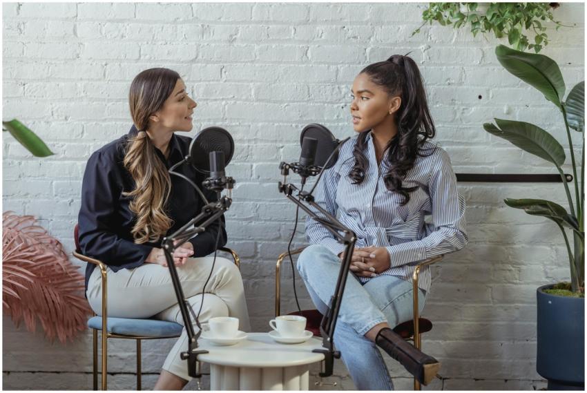 Two women having a lively podcast recording sessio
