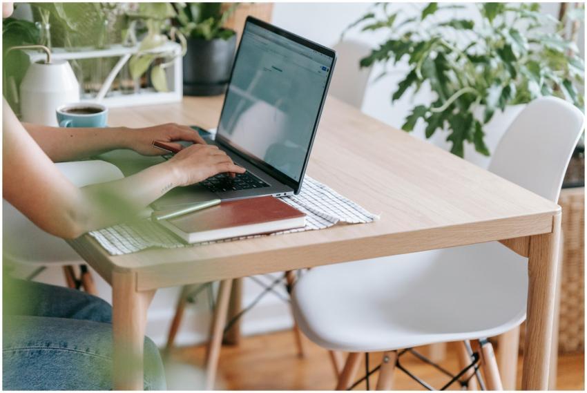 Crop unrecognizable female freelancer browsing int