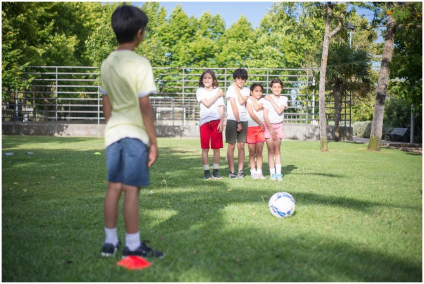 A group of kids enjoy a soccer game outdoors in a