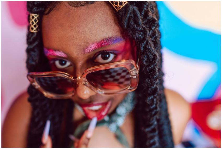 Vibrant portrait of a woman in sunglasses, featuri