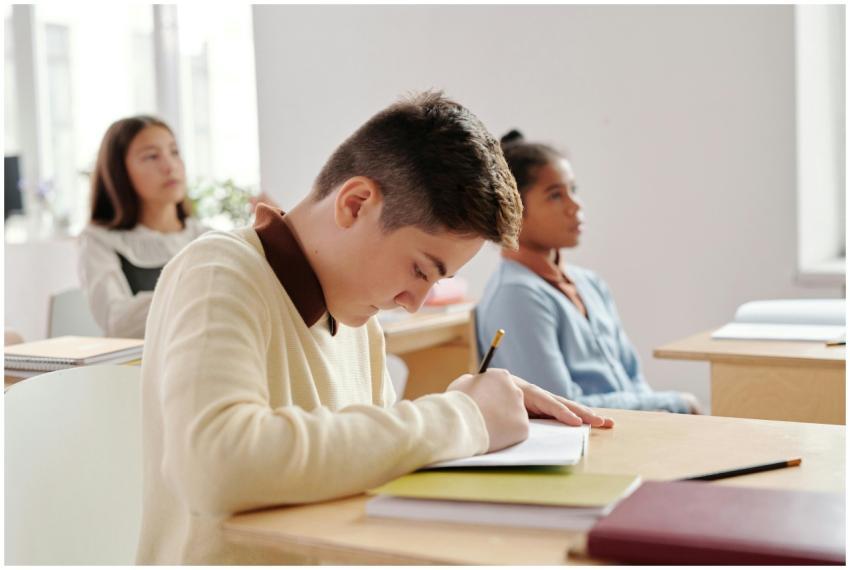 Group of students attentively writing in a classro
