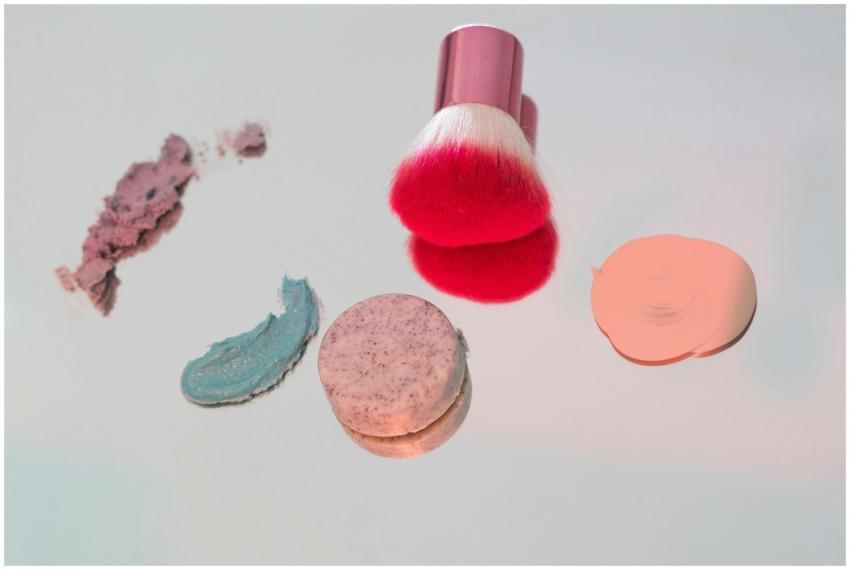 Vibrant makeup brush with various colors and swatc