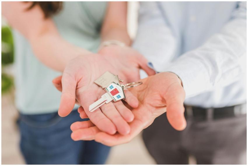Close-up of a couple holding keys, symbolizing hom