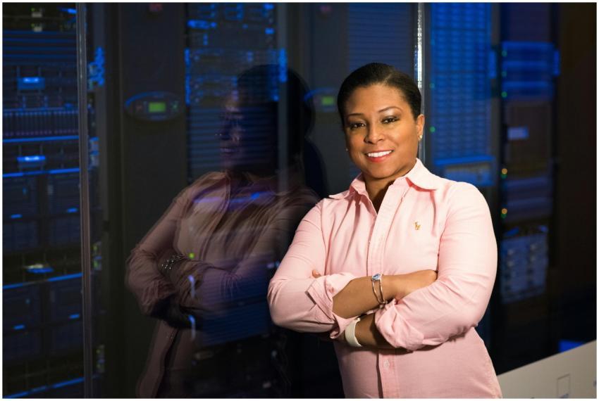 Smiling IT professional with crossed arms in a ser