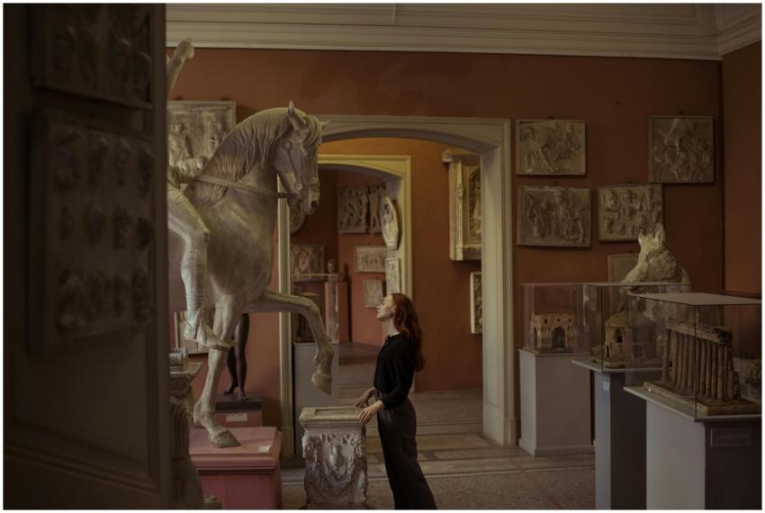 Woman admiring a horse sculpture in an art museum,
