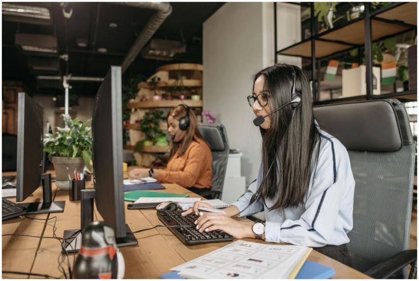 Two women in a modern call center working on compu