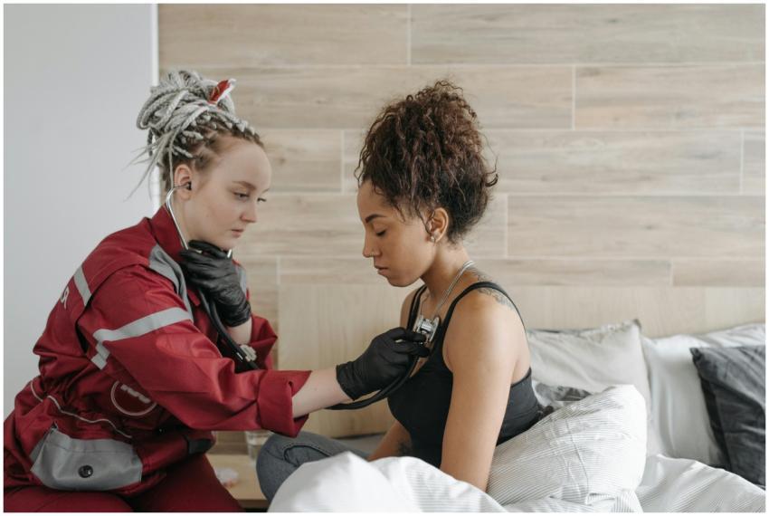A paramedic checks a patient's vital signs in an i