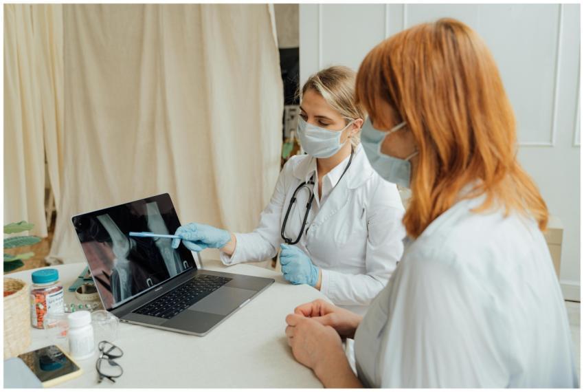 Doctor explains X-ray results to patient using a l