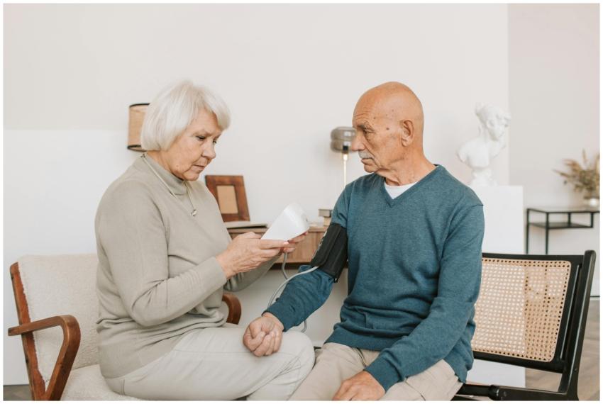 Senior couple measuring blood pressure at home, sh