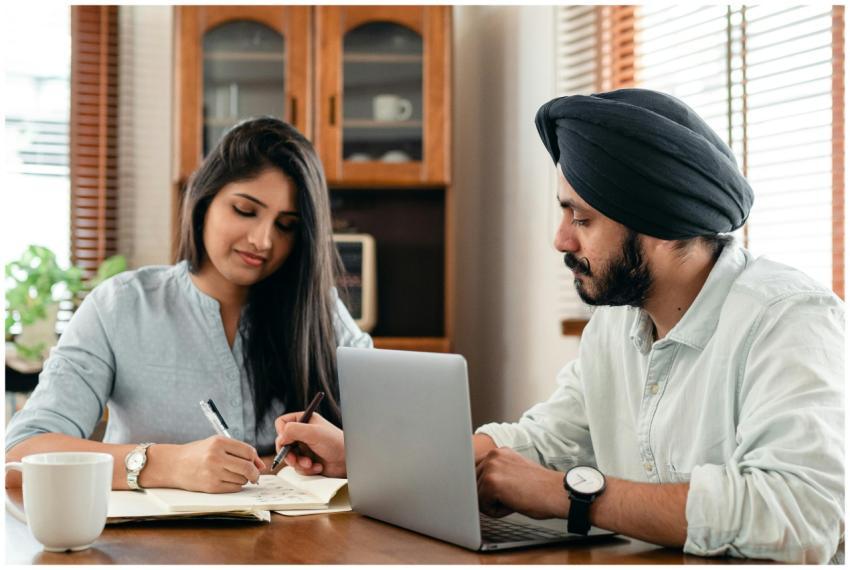 Two young adults studying together indoors, focuse