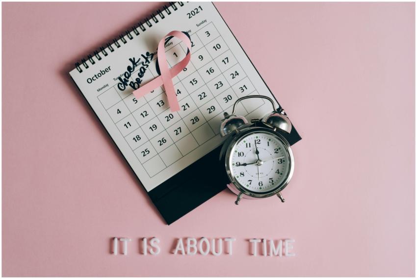 Calendar with pink ribbon, an alarm clock, and the