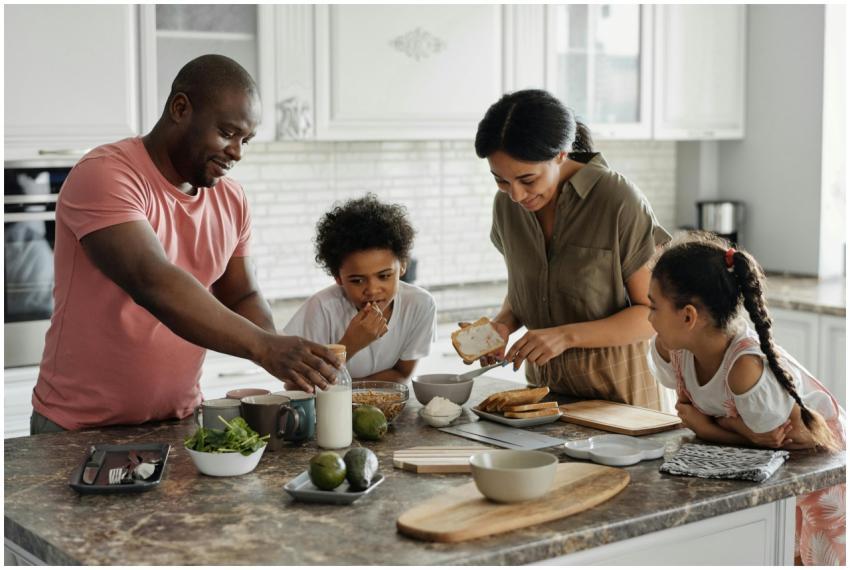 A joyful family enjoys preparing a healthy meal to