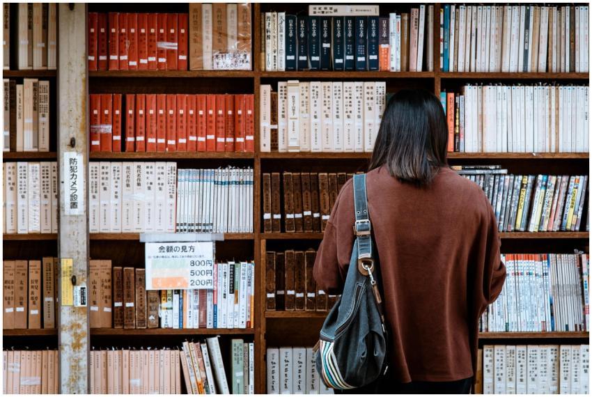 Woman browsing books at a library in Nagano, Japan