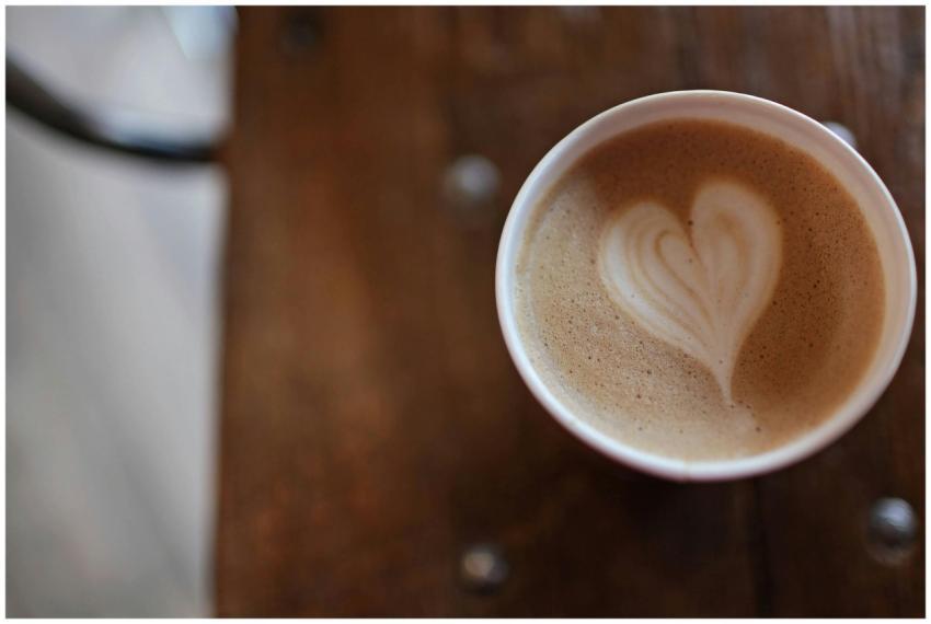 A warm cappuccino with heart-shaped latte art on a
