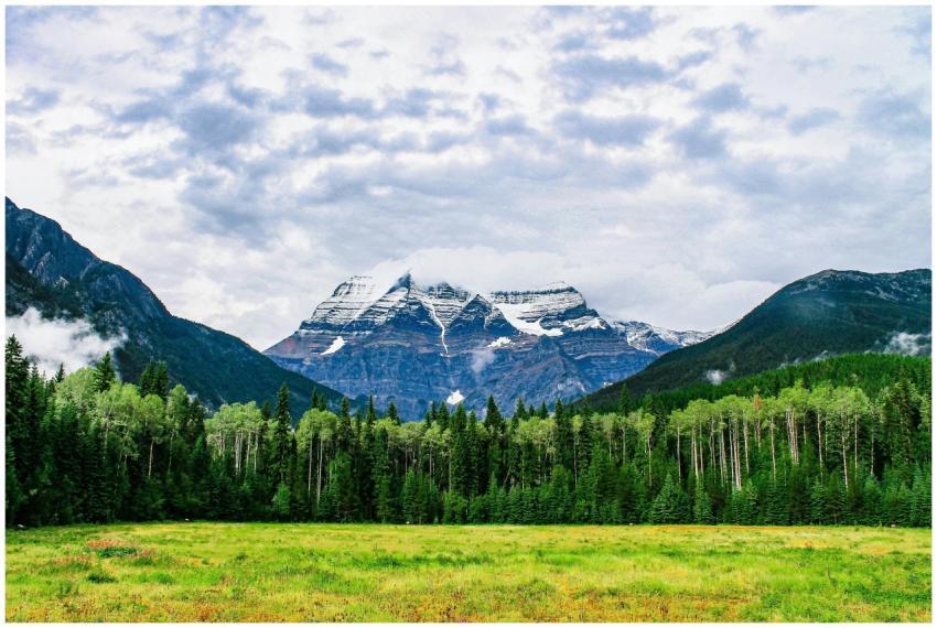 A scenic view of a snow-capped mountain surrounded