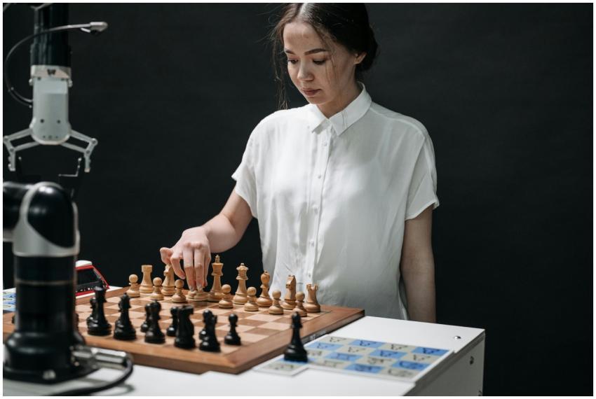A woman plays chess with a robotic arm, illustrati