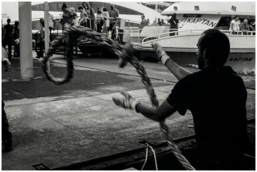 A candid black and white photo capturing a dock wo