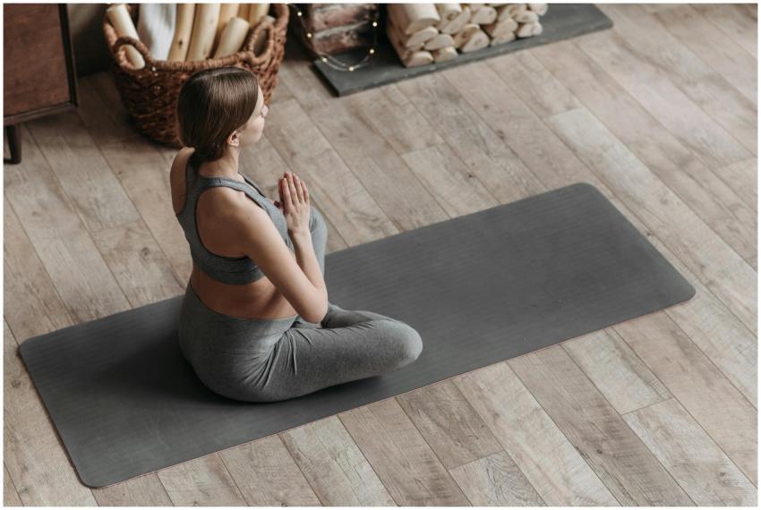 Expectant mother in yoga pose at home, promoting h
