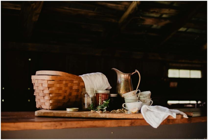 A rustic kitchen scene featuring a basket, brass j