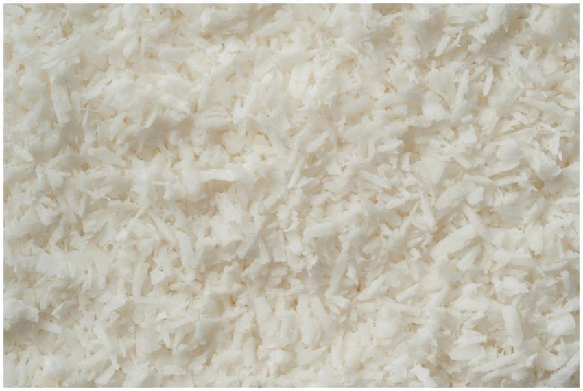 Detailed texture of fresh shredded coconut flakes,