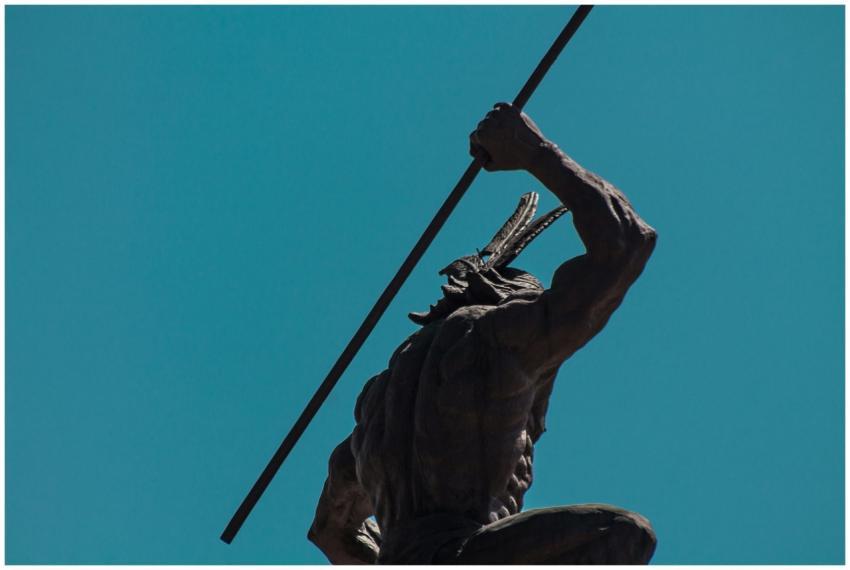 Low angle shot of an indigenous warrior statue wit