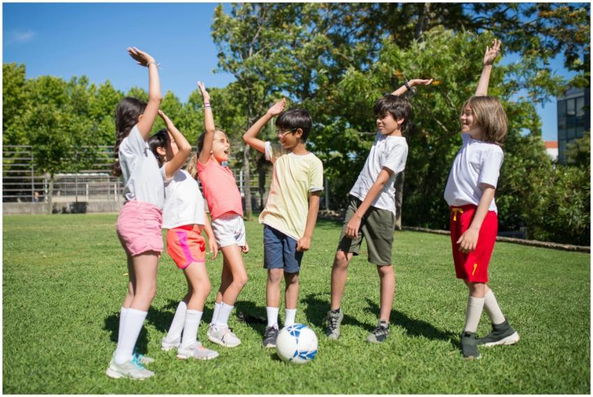 Group of kids enjoying a soccer game outdoors on a