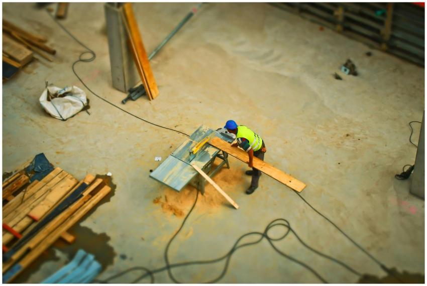 Overhead view of a construction worker using a saw