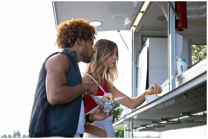 Young couple sharing a meal at a street food truck