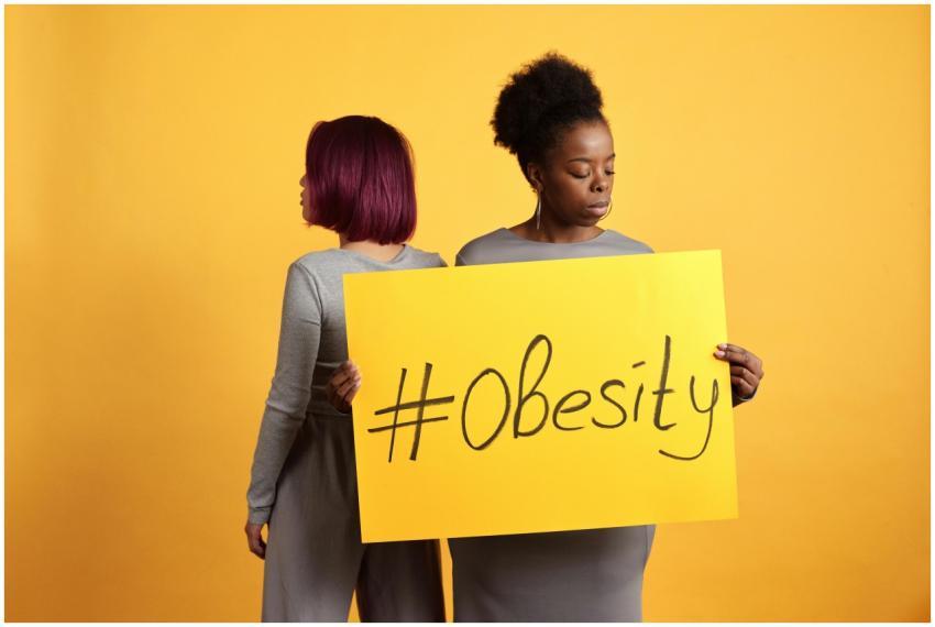 Two women advocate obesity awareness holding a bol
