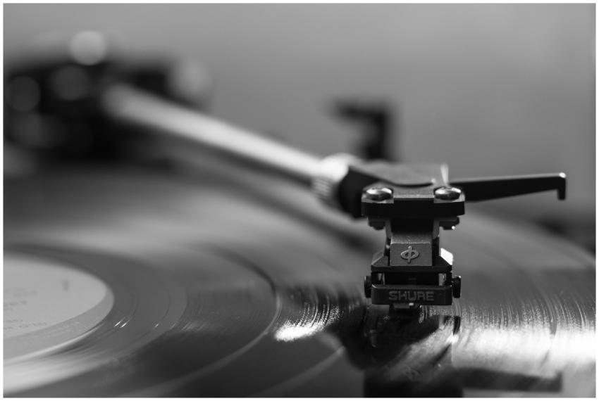Black and white close-up of a turntable playing a
