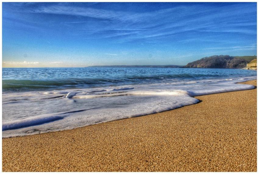 Serene view of a sandy beach in Cornwall, England,