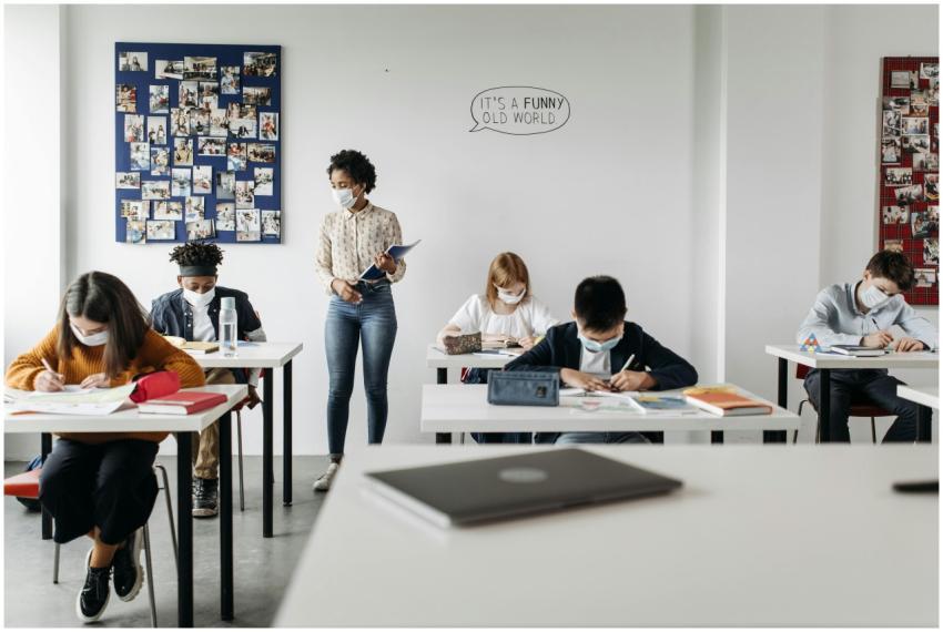 Students and teacher in a classroom wearing masks,