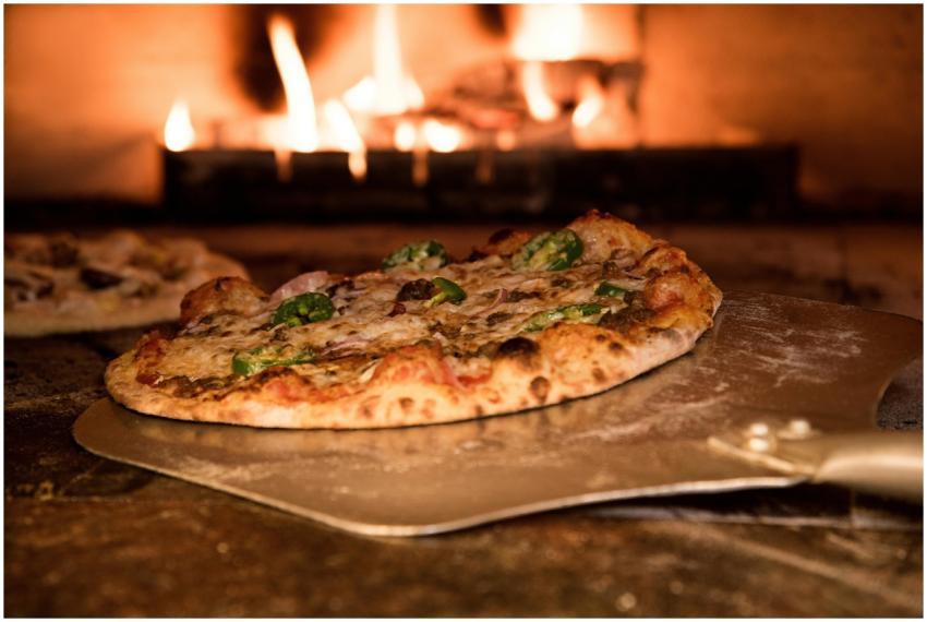 Appetizing gourmet pizza cooked in a wood-fired ov