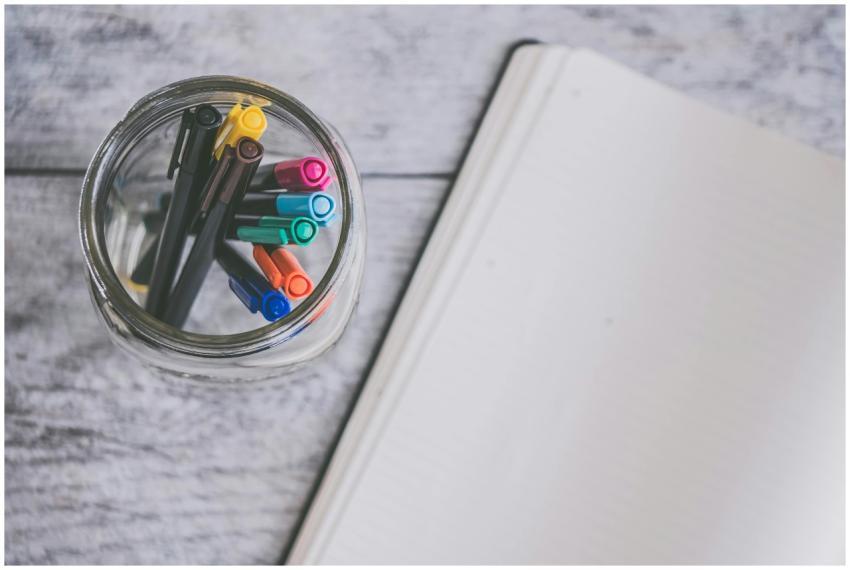 Top view of a glass jar filled with colorful pens