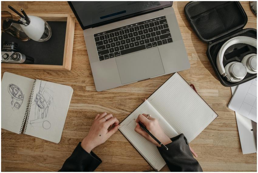 Top view of a creative workspace featuring a lapto