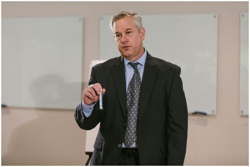 Businessman in suit presenting in office setting,
