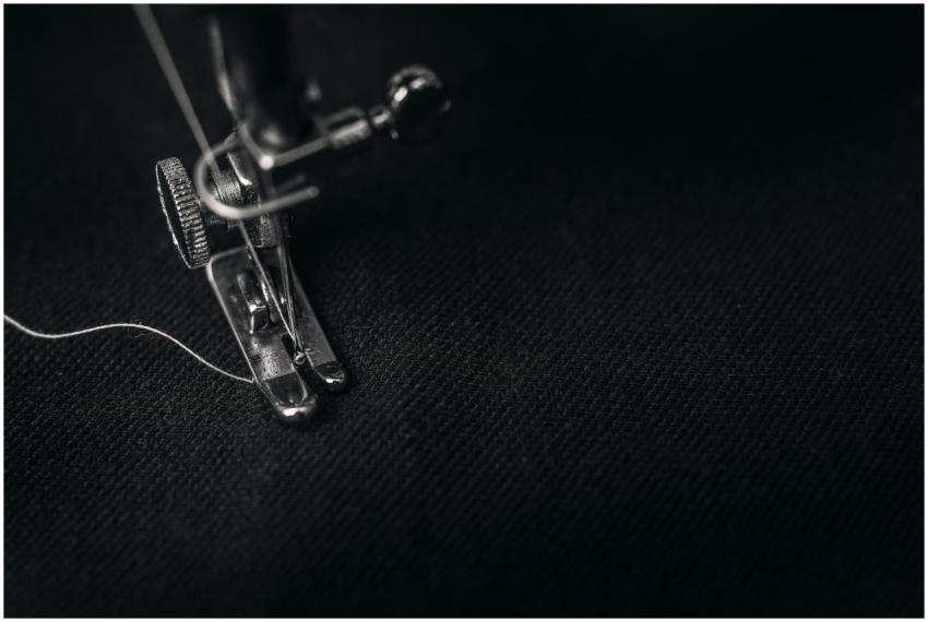 Detailed view of a sewing machine needle stitching