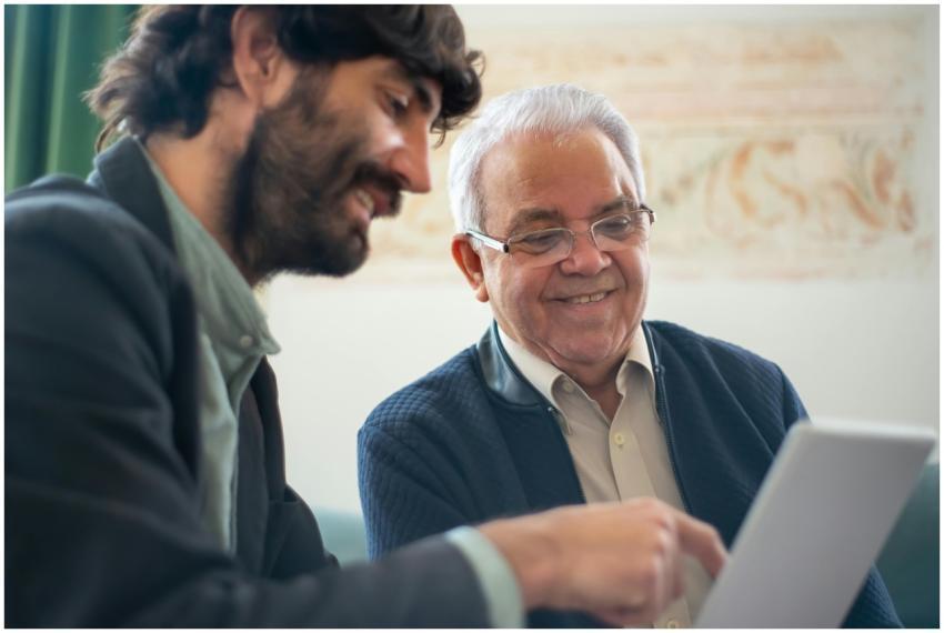 Elderly man discussing business with a younger col