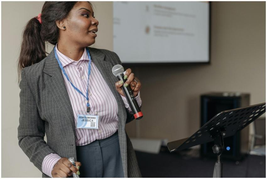Woman in professional attire presenting at a busin