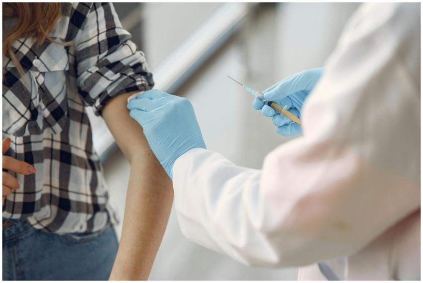 A medical professional giving a vaccination to a p