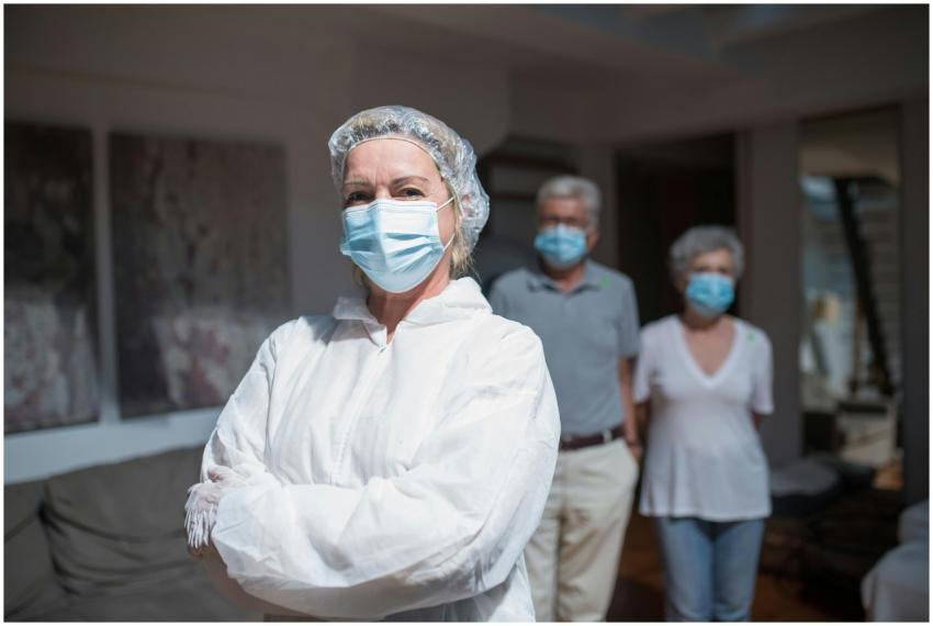 Healthcare worker in protective gear standing with