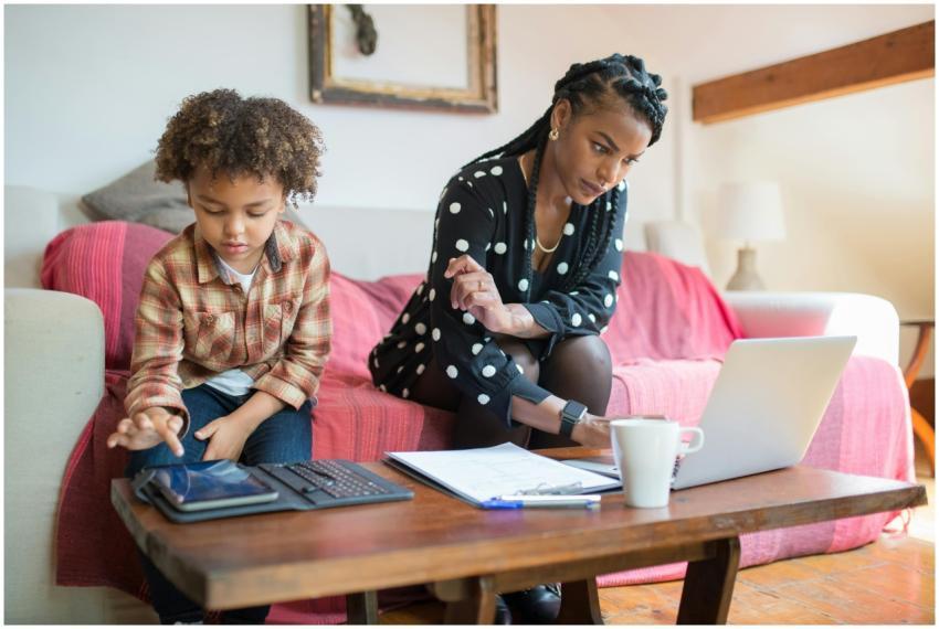 A woman and her son using technology in a cozy liv